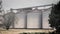 Grain metallic silo building in landscape, big tin seed elevator, agriculture countryside.