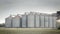 Grain metallic silo building in landscape, big tin seed elevator, agriculture countryside.