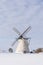 Grain mill on the winter landscape. Dutch windmill and natural background