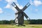 Grain mill on the winter landscape. Windmill and natural background