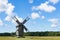 Grain mill on the winter landscape. Windmill and natural background