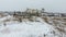 Grain terminal in the winter season. Snow-covered grain elevator in rural areas. A building for drying and storing grain.