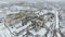 Grain terminal in the winter season. Snow-covered grain elevator in rural areas. A building for drying and storing grain.