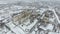 Grain terminal in the winter season. Snow-covered grain elevator in rural areas. A building for drying and storing grain.