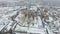 Grain terminal in the winter season. Snow-covered grain elevator in rural areas. A building for drying and storing grain.