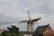 Grain windmill Windlust at Kortenoord with flags on it in Nieuwerkerk aan den IJssel in the Netherlands