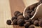 Grains allspice on a wooden board.