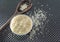 Grains of cereal rice on a dark background in a jar next to wooden spoon