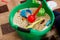 grains and cereals are mixed in bowl with small toys, toys for autism, autism, child development, sensory activities
