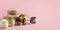 Grains, cereals, nut, dry fruits in glass jars over pink background with copy space. Clean eating, healthy, vegan diet concept