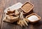 Grains, flour and wheat ears on a wooden table