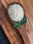 Grains rice on a wooden spoon close up, macro