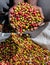 Grains of ripe coffee in the handbreadths of a person. East Africa. Coffee plantation.