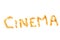 Grains of yellow roasted popcorn lined in the word `cinema`