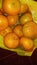 grainy and blurry picture of orange fruit bunch of oranges round yellow skin fruit