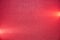 Grainy dark red background with two short horizontal light red beams of light