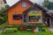 GRAMADO, BRAZIL - MAY 06, 2016: nice orange house with some plants and a cart on the front garden