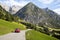 Gramais, Austria, 12 September 2015: Red car driving on alpine road, Gramais, Austrian