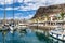 Gran Canaria, Spain - Feb 21, 2023: Colorful canarian fishing boats at the harbor in Puerto de Mogan, Gran Canaria,Spain