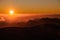 GRAN CANARIA, SPAIN - NOVEMBER 6, 2018: Colorful down from Roque Nublo mountain under the sky in bright orange mist