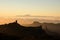 GRAN CANARIA, SPAIN - NOVEMBER 6, 2018: Roque Nublo mountain under the sky in yellow mist and a Tenerife island