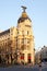 Gran Via and the iconic Metropolis Building sourrounded by trational spanish architecture at sunrise