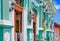 GRANADA, NICARAGUA, MAY, 14, 2018: Outdoor view of facade buildings with turquoise wall and wooden door in the historic