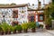 Granada, Spain, April 06, 2018: : Facade of a traditional house with decorative ceramic plates and pots of colorful flowers in the
