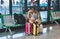 Granada / Spain - August 22 2019: A young man checking his phone at a train station with his luggage