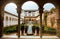 GRANADA, SPAIN - FEBRUARY 10, 2015: An archway to patio with fountains and cutted brushes at Generalife Gardens of Alhambra palace