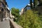 Granada, Spain - September 14th 2017: A narrow street runs along the course of the River Darro, Granada, Spain