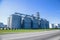 Granary. Modern agro-processing plant for the storage and processing of grain crops. Large metal barrels of grain. Granary