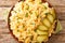 Granatir famous dish Pasta with potatoes and onions served with pickels close-up in a plate. horizontal top view