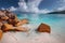 Grand anse, La Digue island, Seychelles. Sandy beach with orange granite boulders and azure ocean lagoon and beautiful