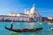 Grand Canal with gondola against Basilica Santa Maria della Salute in Venice, Italy