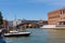 Grand Canal in Venice with boats and gandules docket motor boat near the bridge. Colorful residential house and small bridges