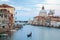 Grand Canal in Venice with gondola and Saint Mary of Health basilica in Italy