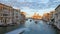 Grand Canal in Venice time lapse with motorboat and clouds passing, Saint Mary of Health at dusk in Italy