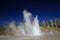 Grand geyser erupting on background of blue sky,Yellowstone NP,USA