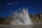 Grand geyser erupting on background of blue sky,Yellowstone NP,USA