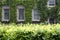 Grand House Framed by Hedge