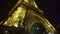 Grand iron construction of Eiffel Tower sparkling with lights in night Paris