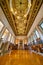 Grand Library Interior with Ornate Ceiling and Central Staircase