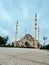 grand mosque in white with the golden howl moon on the dome and a white background, creative abstract photography