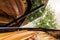 The grand piano interior with visible strings In the background a blurred Christmas tree decorated with ornaments