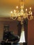 Grand piano and lighted chandelier