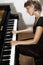 Grand piano player. Pianist woman playing piano