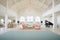 grand room with white arcades and chandeliers