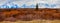 Grand Teton Mountain Range Against a Reddish-Orange Grass Foreground