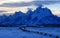 Grand Tetons split rail fence view at alpenglow twilight sunset under lenticular clouds in Grand Tetons National Park in Wyoming